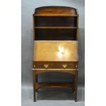 An Edwardian Mahogany Line Inlaid Bureau Bookcase with open shelves and a fall front enclosing a