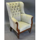 A Victorian Mahogany Drawing Room Wingback Armchair, the button upholstered back above a padded seat
