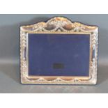 A Sterling Silver Photograph Frame Embossed Bows and Swags, 19 x 22 cms