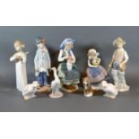 A Lladro Figurine of a Seated Girl with a Vase of Flowers, together with four other Lladro