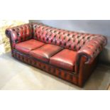 A Burgundy Leather and Button Upholstered Chesterfield Sofa, 197 cms long