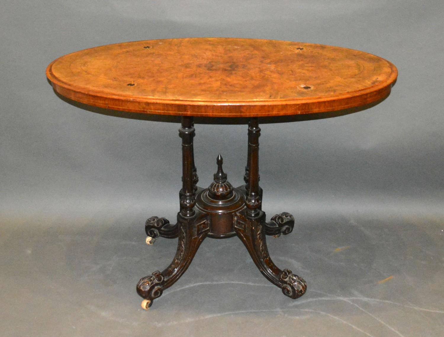 A Victorian Burr Walnut and Marquetry Inlaid Oval Centre Table, the inlaid moulded top above
