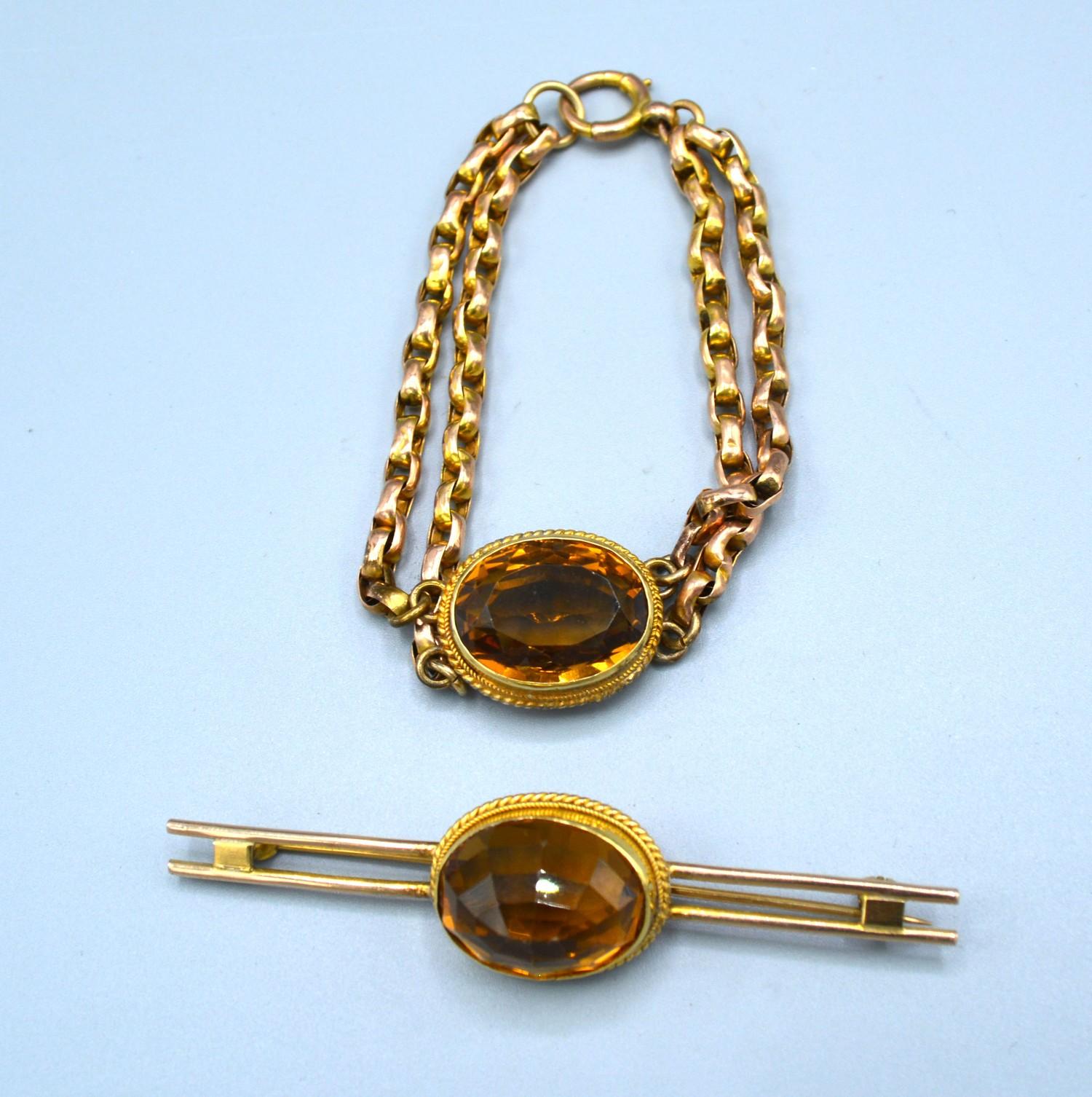 A Yellow Metal Double Linked Bracelet set single oval citrine together with a similar yellow metal