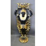 A Floor Standing Torchere in the form of an Egyptian Figure with gilt highlights, 134 cms tall