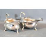 A Pair of George III Silver Sauce Jugs with shaped scroll handles and hoof supports, London 1761,