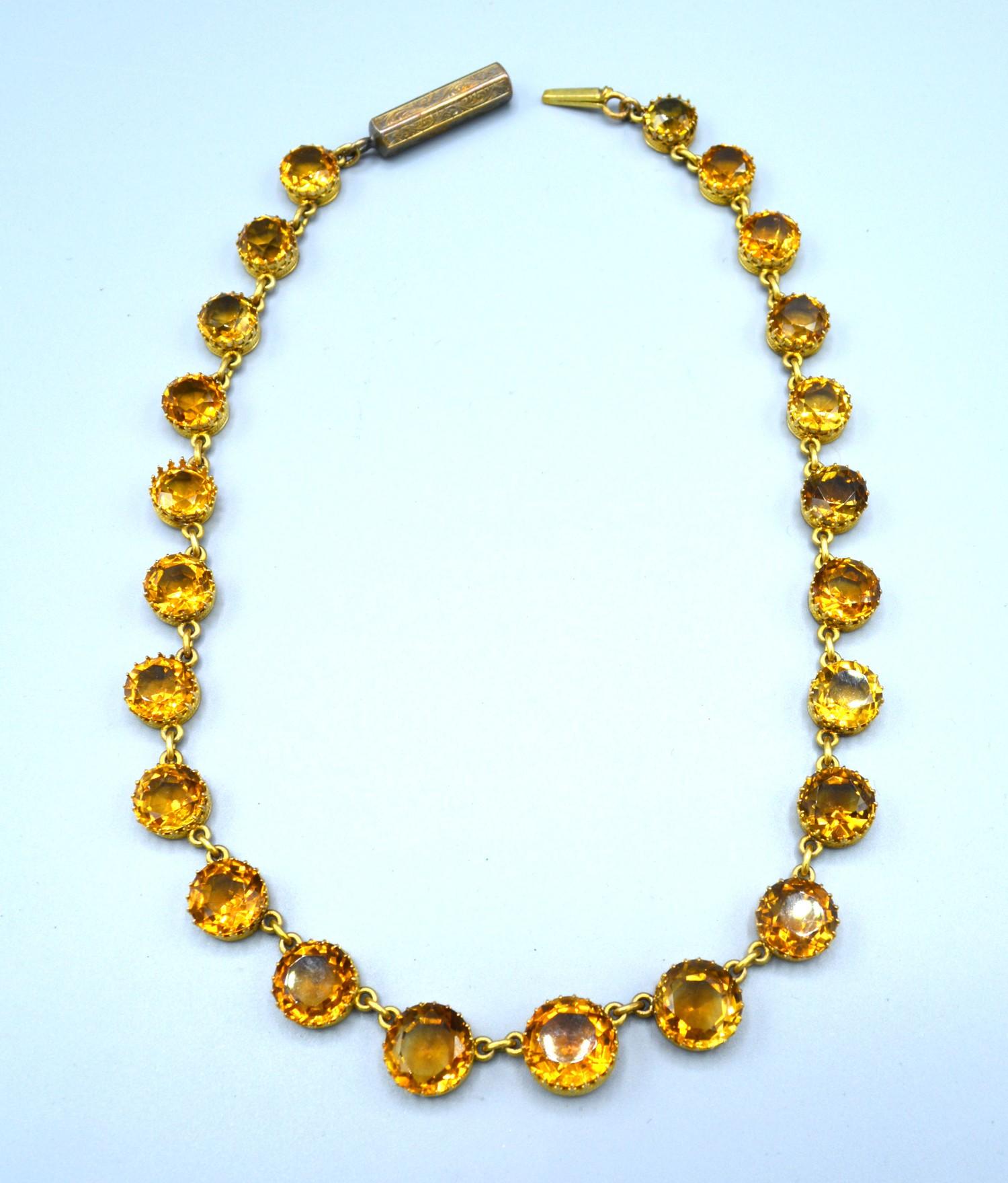 A Yellow Metal Citrine Set Necklace with graduated stones and interspaced with links, 38 cms long