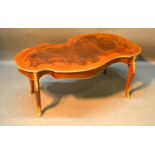 A French Marquetry Inlaid and Gilt Metal Mounted Coffee Table, the shaped top above cabriole legs