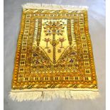 A North West Persian Woollen Prayer Rug with an all-over design upon a cream ground within
