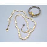 A Cultured Graduated Pearl Necklace, the clasp set with a single diamond together with a 9ct. gold