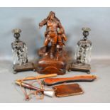 A Carved Wooden Group together with a pair of patinated metal candlesticks with facet cut glass