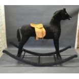 A Large Plush Covered Rocking Horse with wooden stand, 146 cms high, 187 cms long