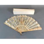 A Mother-Of-Pearl and Gauze Leaf Fan with sequin decorated mother-of-pearl guards and sticks and