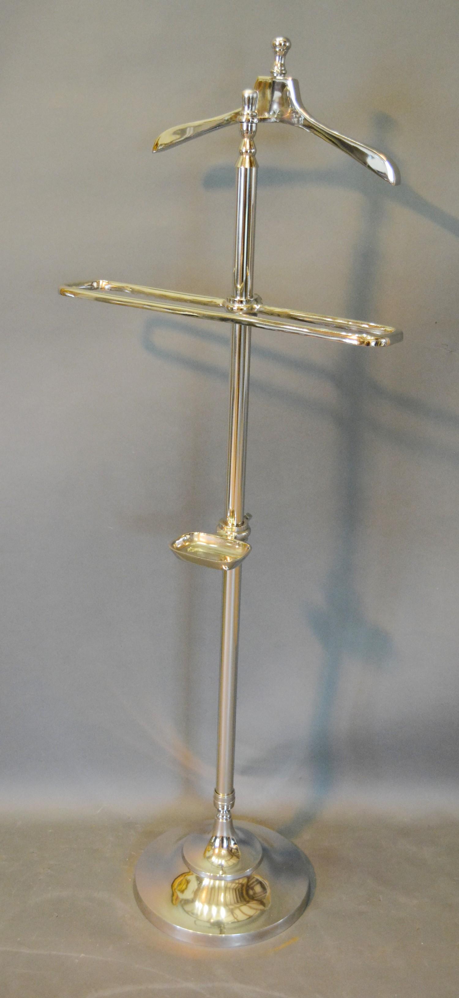 A Chromium Plated Valet Stand with hanger, rail and dish upon circular base 143cm tall