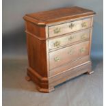A 19th Century Continental Oak Small Chest, the moulded top above three long drawers with brass