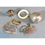 A Birmingham Silver and Mother of Pearl Baby's Rattle together with three silver decanter labels and