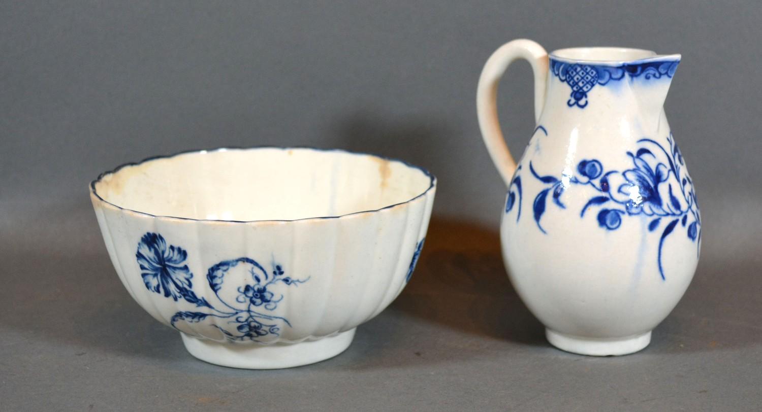 A First Period Worcester Cream Jug together with a similar small bowl