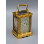 A Brass Cased Carriage Clock, the silvered dial with circular enamel face and with porcelain side