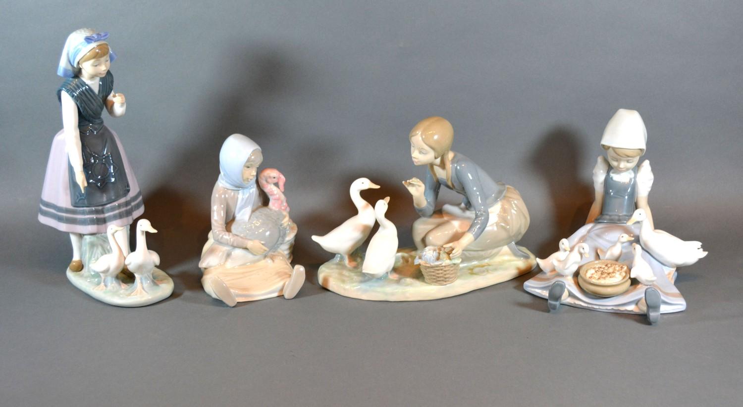 A Lladro Figurine in the form of a Girl Feeding Ducks together with three other similar Lladro