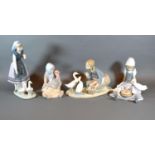A Lladro Figurine in the form of a Girl Feeding Ducks together with three other similar Lladro