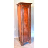 A Victorian Mahogany Wardrobe, the moulded cornice above a single arched door raised upon bracket