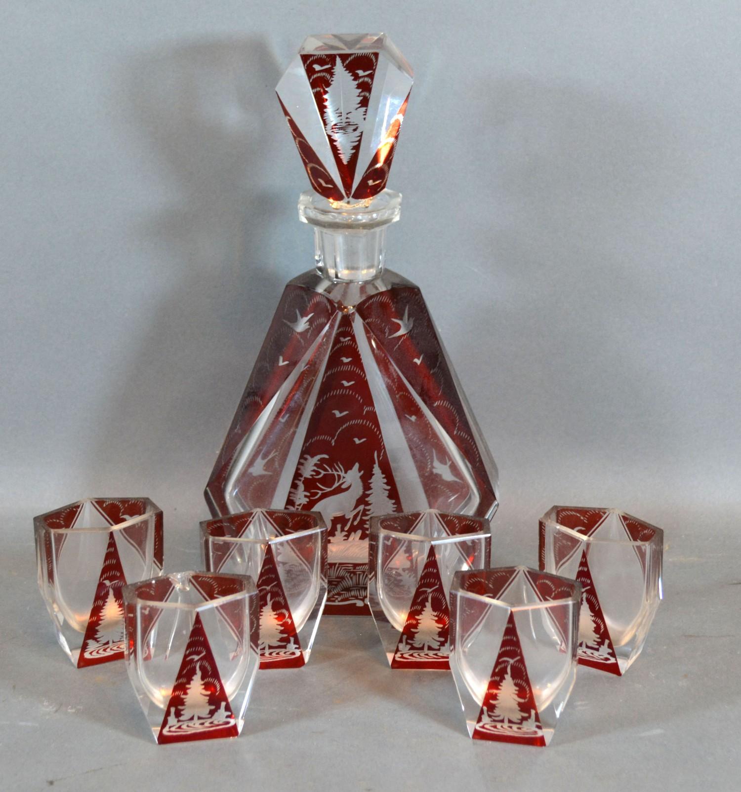 A Bohemian Ruby and Clear Glass Drinking Set comprising Decanter with stopper and six small Glasses