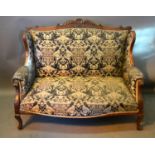 An Edwardian Mahogany Sofa, the shaped scroll back above similar arms with cabriole legs, 126 cms