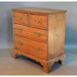 A 19th Century Pine Chest of two short and two long drawers with brass handles raised upon bracket