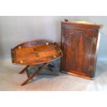 A Folding Butler's Tray with Stand together with a George III oak hanging corner cabinet