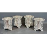 A Set of Four Silver Plated Bottle Stands of pieced embossed form upon shaped feet 12cm tall