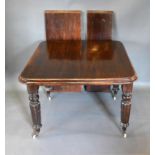 A Victorian Mahogany Wind-Out Extending Dining Table, the moulded top above four reeded tapering