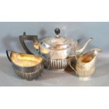 An Edwardian Silver Three Piece Tea Service comprising teapot, cream jug and two handled sucrier,
