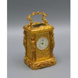A Brass Cased Miniature Carriage Clock of Rococo Form with lever escapement and enamel dial, 7cms