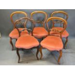 A Set of Four Victorian Mahogany Balloon Back Dining Room Chairs, each with a stuff over seat raised