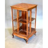 An Edwardian Mahogany Marquetry Inlaid Revolving Bookcase, the marquetry inlaid top above an