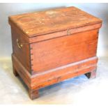 A 19th Century Pine Trunk with brass end handles raised upon square legs, 80 cms wide, 52 cms
