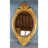 A 19th Century French Gilded Oval Wall Mirror, 79 x 46 cms