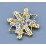 An 18ct. Gold Diamond Set Brooch of Abstract Star Form, the central diamond approximately 0.40 ct.