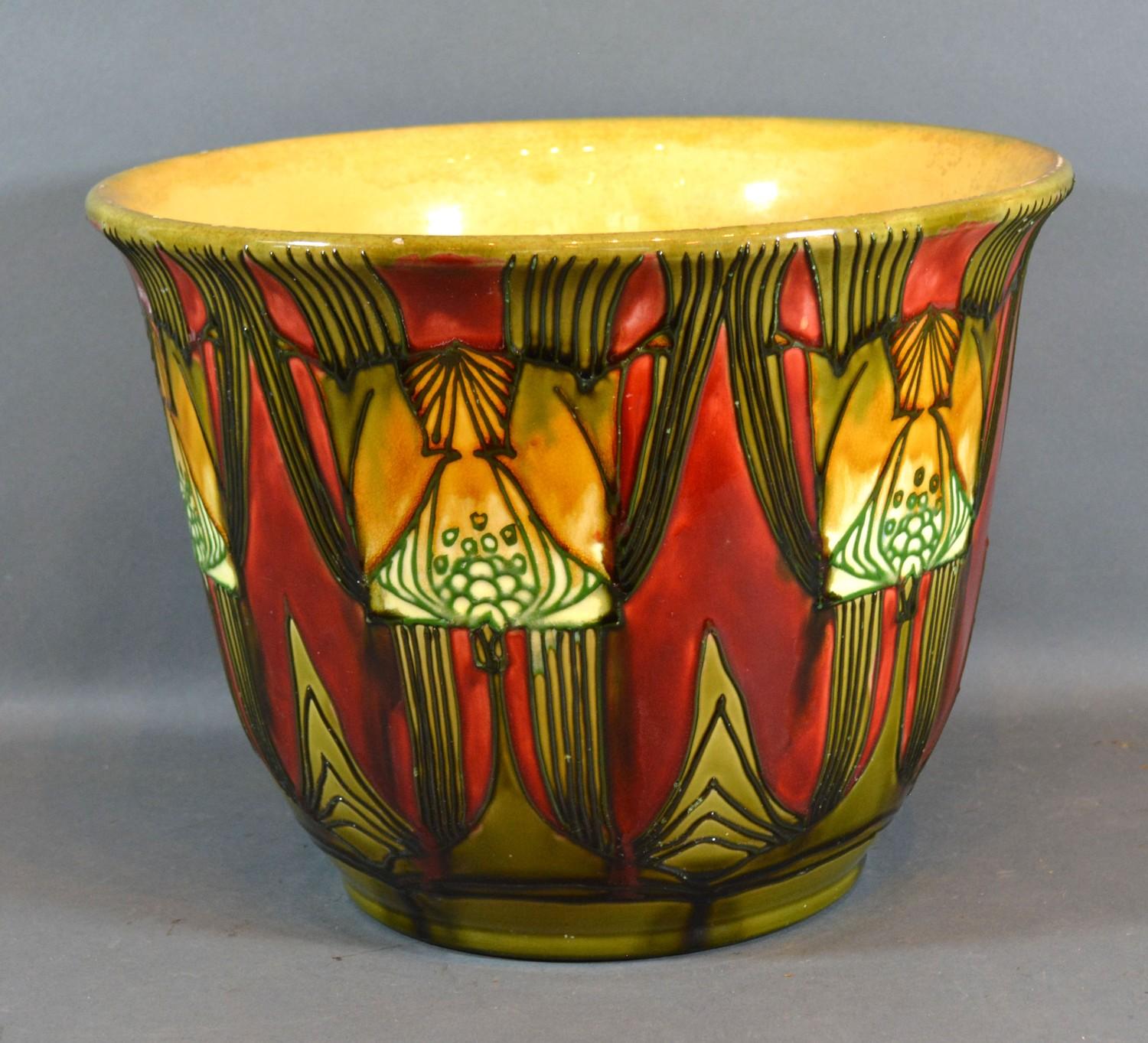 A Minton Secessionist Number 71 Jardiniere with Stylised Decoration upon a red and green ground