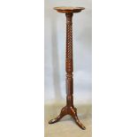A Mahogany Torchere, the circular top above a spiral carved column and outswept legs with pad