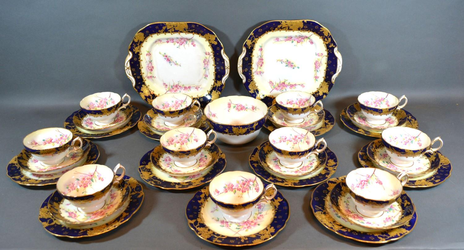 A Hammersley Porcelain Tea Service comprising eleven cups, ten saucers, eleven plates, two serving