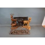 A 19th Century Black Forest Folding Book Stand together with two similar carved models of Stags