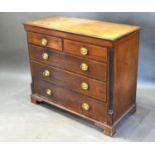 An Early 19th Century Mahogany Straight Front Chest of two short and three long drawers with oval