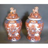 A Pair of Chinese Covered Vases decorated in iron red 49cm tall