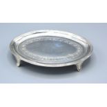 A George III Silver Teapot Stand of oval engraved form with four scroll feet, London 1805, maker