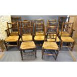 A Harlequin Set of Twelve Early 19th Century Elm Lancashire Chairs, each with spindle backs above
