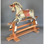 A Dapple Grey Rocking Horse with wooden stand, 101 cms high, 127 cms long