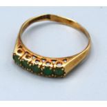 A 9ct. Gold Five Stone Emerald Ring claw set, 2.6 gms, ring size T