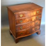 A Reproduction Mahogany Serpentine Fronted Chest of Drawers, the moulded top above four graduated