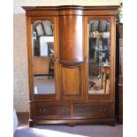 An Edwardian Mahogany Marquetry Inlaid Wardrobe, the semi bow fronted wardrobe above a central panel