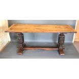 An Early Oak Refectory Dining Table, the rectangular planked top above twin end carved and lobed